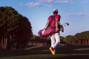 golfer walking and carrying golf bag